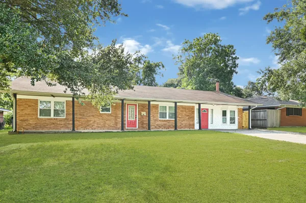 a big house with a big yard and large trees