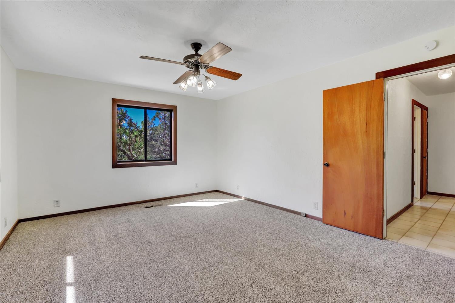 10265 Newtown Road Nevada City, CA 95959 - Photo 12 of 35 an empty room with windows and fan