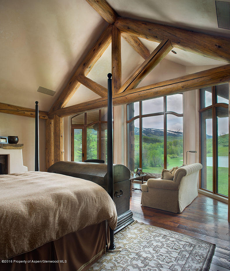 1500 Owl Creek Ranch Road Aspen, CO 81611 - Photo 8 of 18 a bed room with a bed and a large window