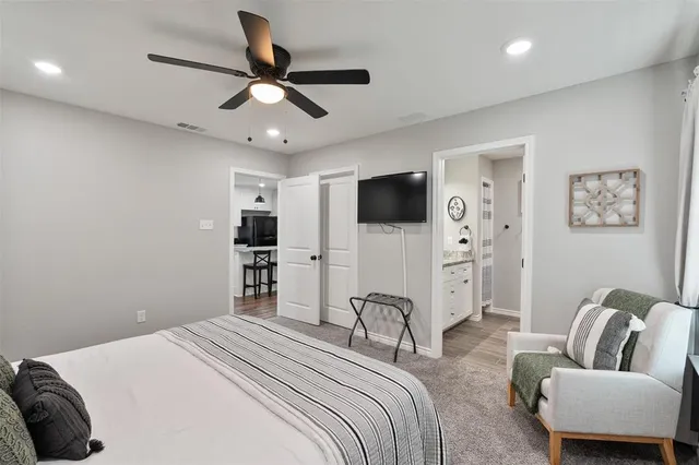 a bedroom with a bed couch and a window