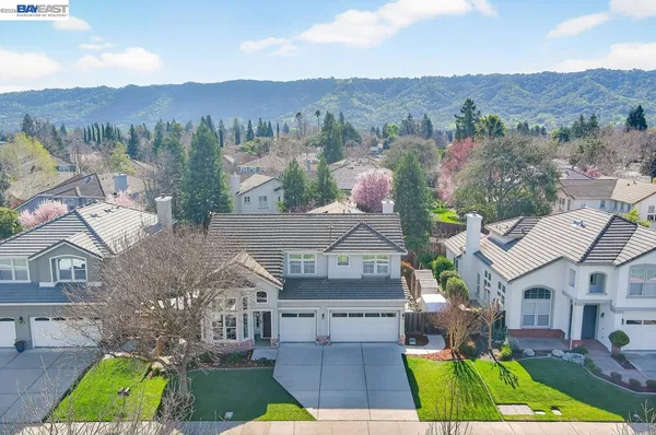an aerial view of multiple houses with a yard