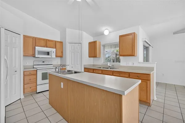a kitchen with stainless steel appliances a stove sink and cabinets