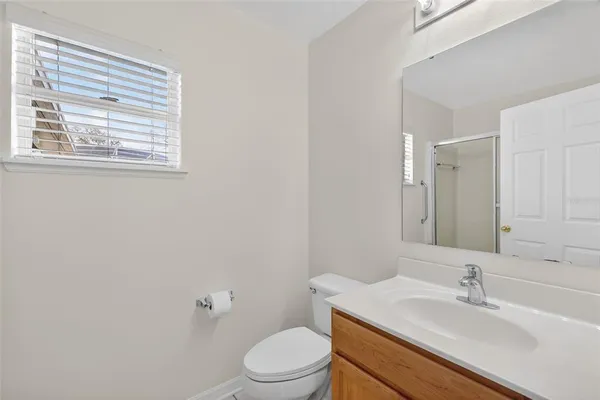 a bathroom with a sink a toilet and mirror