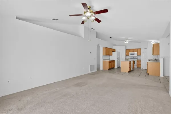 a view of a living room and a ceiling fan window