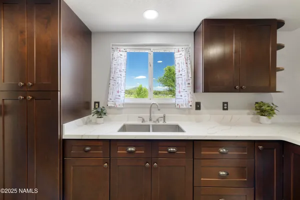 a bathroom with a double vanity sink and mirror
