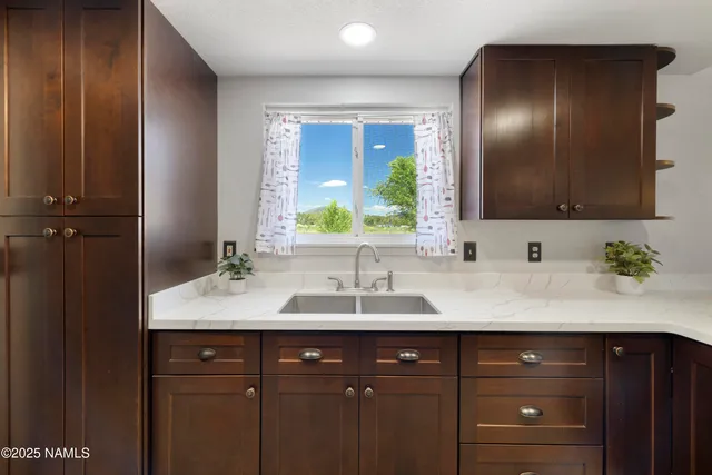 a bathroom with a double vanity sink and mirror