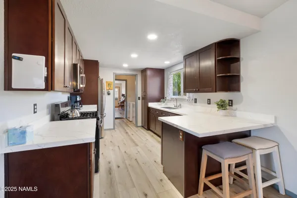 a kitchen with a sink cabinets and wooden floor