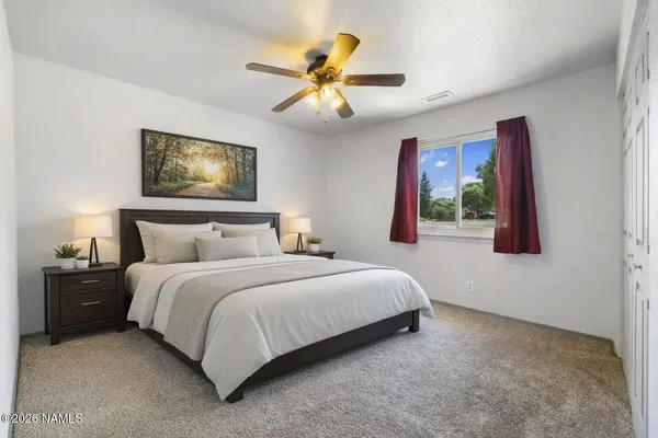 a bedroom with a bed and window