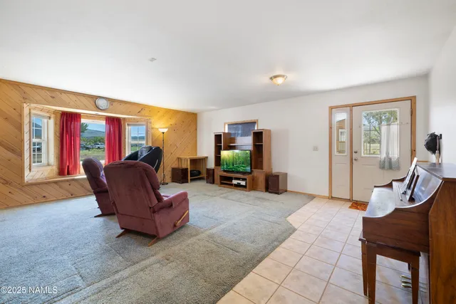 a view of a livingroom with furniture and a flat screen tv