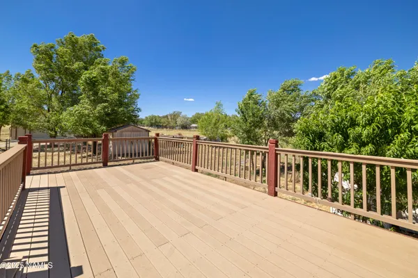 a view of a balcony with wooden floor
