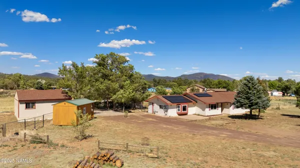a roof deck with table and chairs