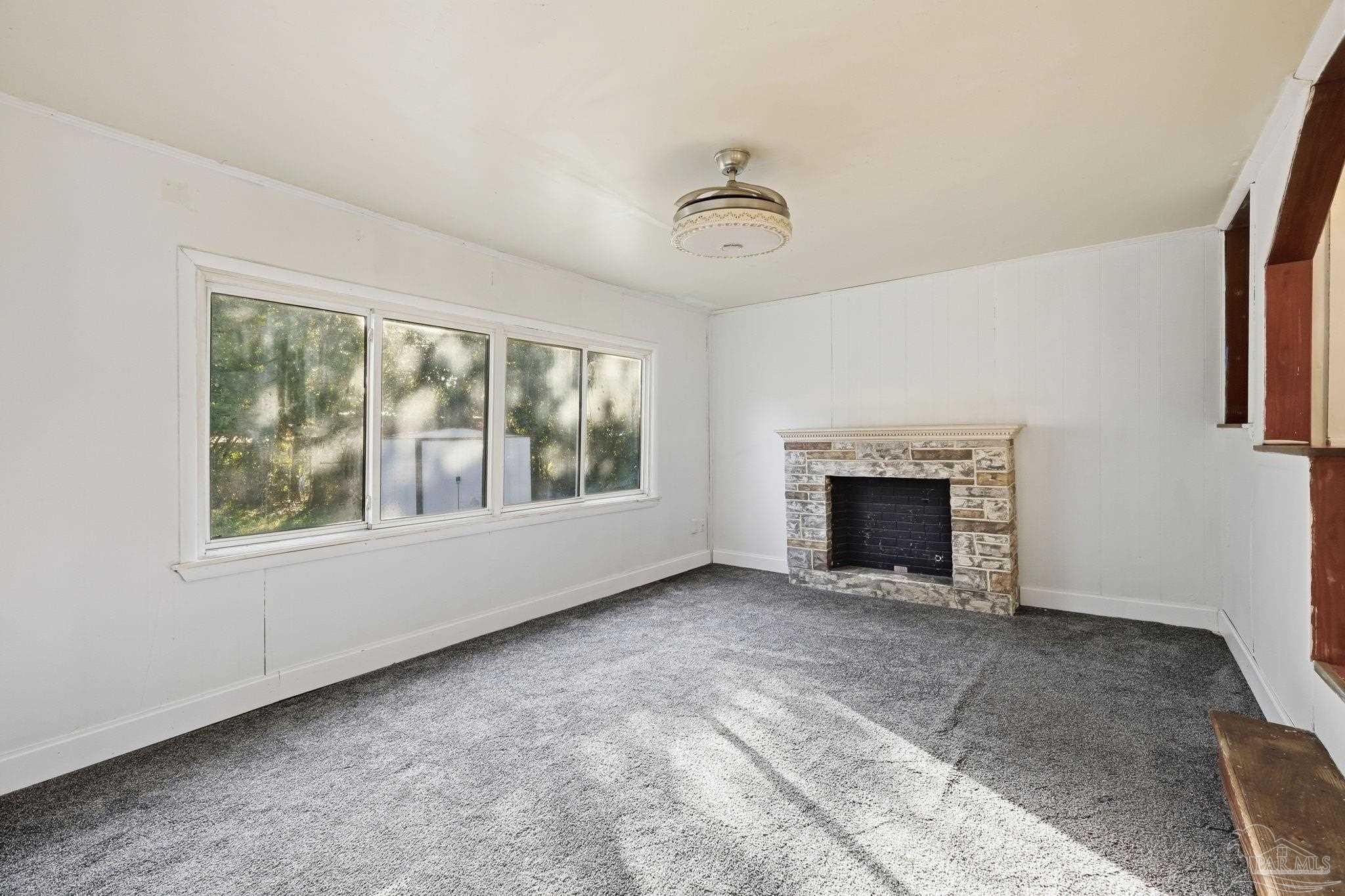 525 Pelham Road Pensacola, FL 32507 - Photo 12 of 28 an empty room with windows and fireplace