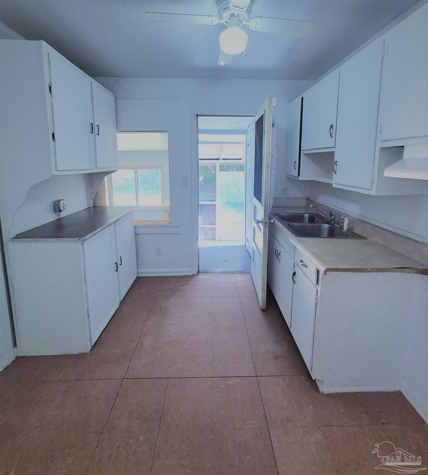 525 Pelham Road Pensacola, FL 32507 - Photo 14 of 28 a kitchen with granite countertop a sink a stove and cabinets
