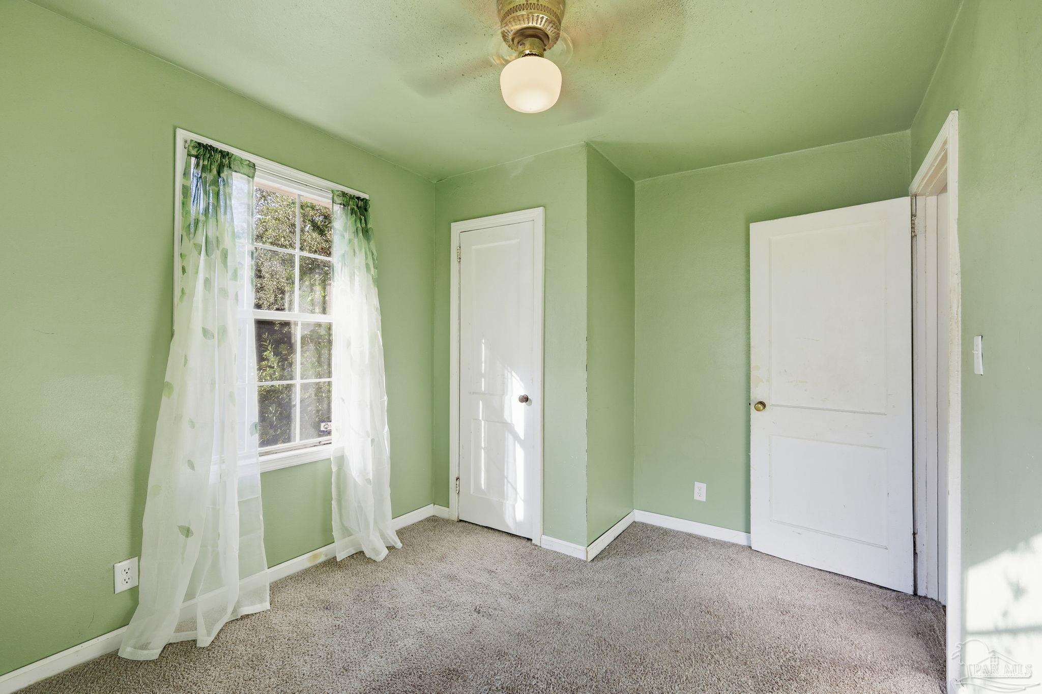 525 Pelham Road Pensacola, FL 32507 - Photo 17 of 28 a view of an empty room with a window