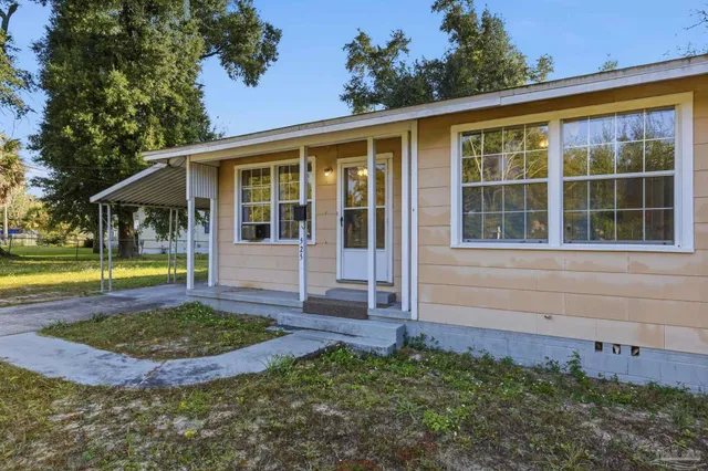a view of house with backyard outdoor seating and entertaining space