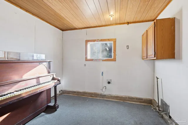 a view of room with window and cabinet