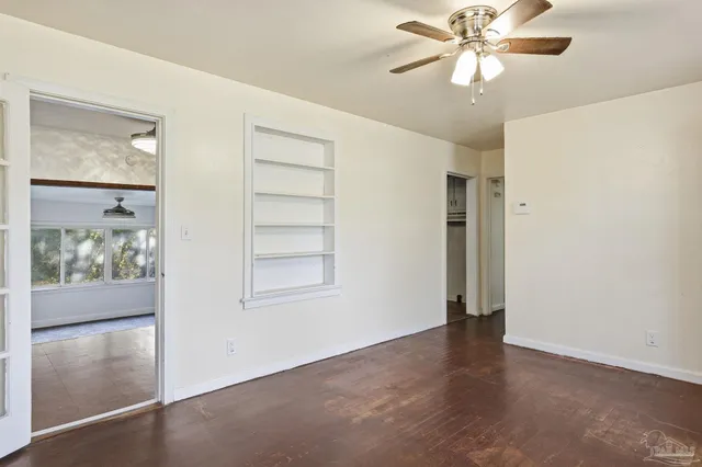 wooden floor in an empty room with a window