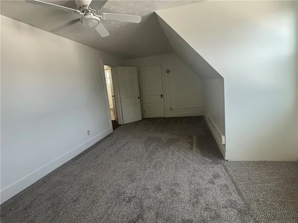 a view of an empty room with a ceiling fan