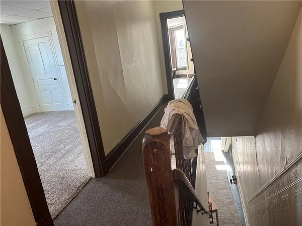 a view of staircase with railing and a window