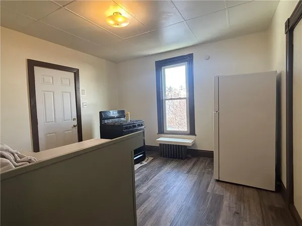 a view of a livingroom with wooden floor and a window