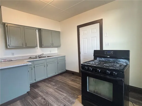 a kitchen with a stove and a sink
