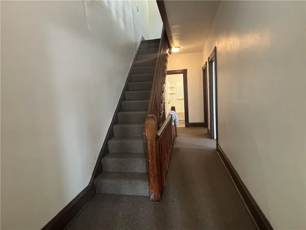 a view of entryway and gallery with wooden floor