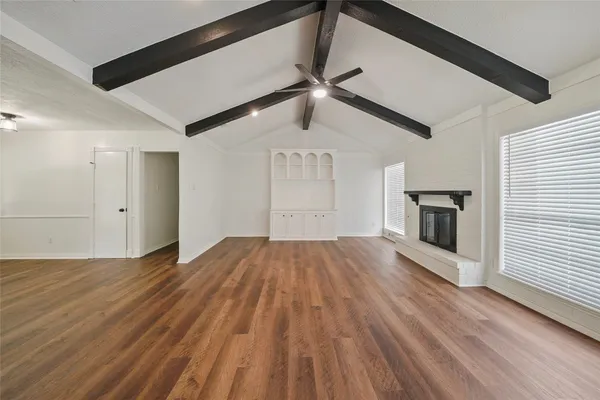 wooden floor in an empty room with a fireplace