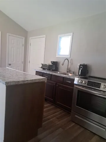 a kitchen with a sink stove and cabinets