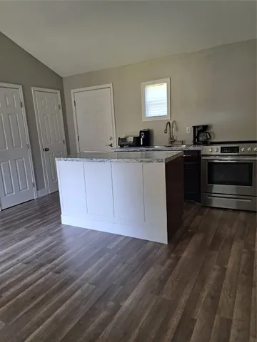 a kitchen with wooden floors and a sink