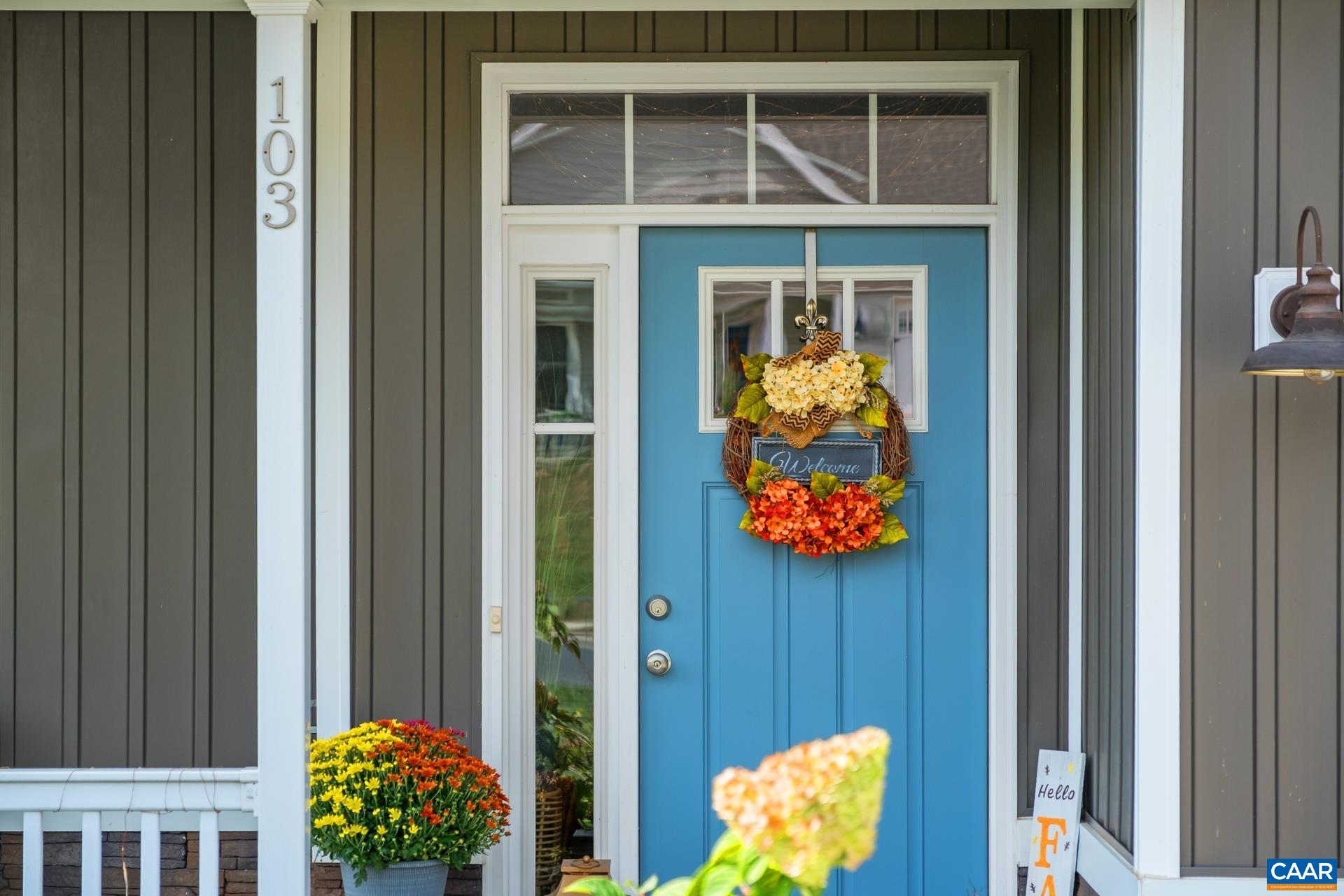 103 Oakstone Run Staunton, VA 24401 - Photo 8 of 42 a vase of flowers sitting on a wooden floor in front of a door