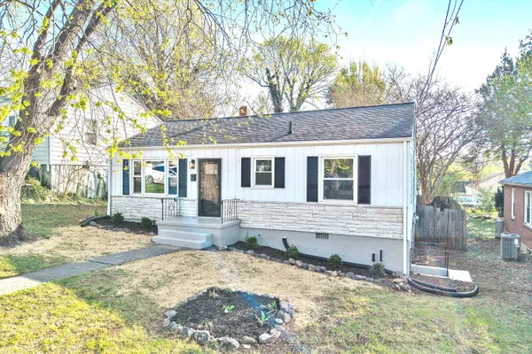 a front view of a house with a yard covered in snow