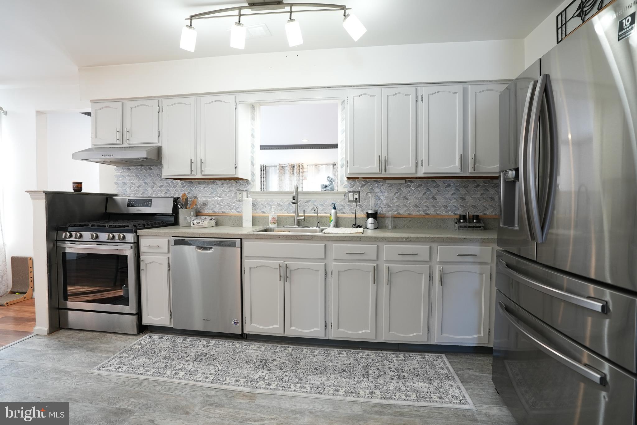 18 Cobblestone Court Sicklerville, NJ 08081 - Photo 12 of 56 a kitchen with stainless steel appliances granite countertop a refrigerator sink and stove