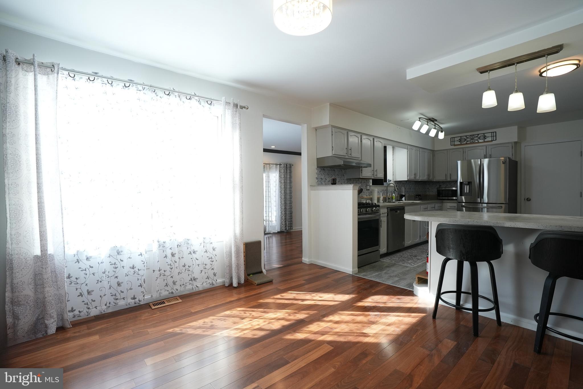 18 Cobblestone Court Sicklerville, NJ 08081 - Photo 13 of 56 a kitchen with kitchen island a refrigerator and a table
