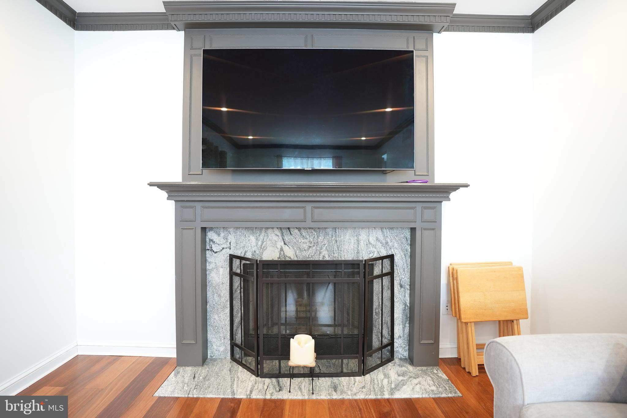 18 Cobblestone Court Sicklerville, NJ 08081 - Photo 16 of 56 a living room with a fireplace and a wooden floor