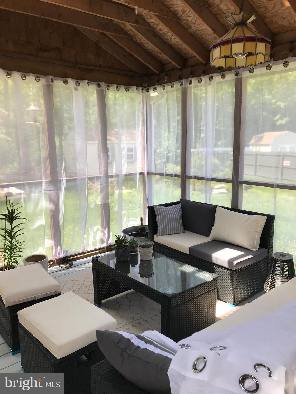 18 Cobblestone Court Sicklerville, NJ 08081 - Photo 25 of 56 a outdoor sitting area with furniture and floor to ceiling window