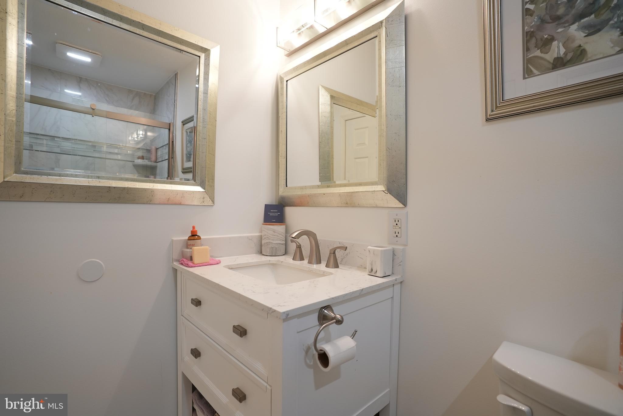 18 Cobblestone Court Sicklerville, NJ 08081 - Photo 31 of 56 a bathroom with a sink and a mirror