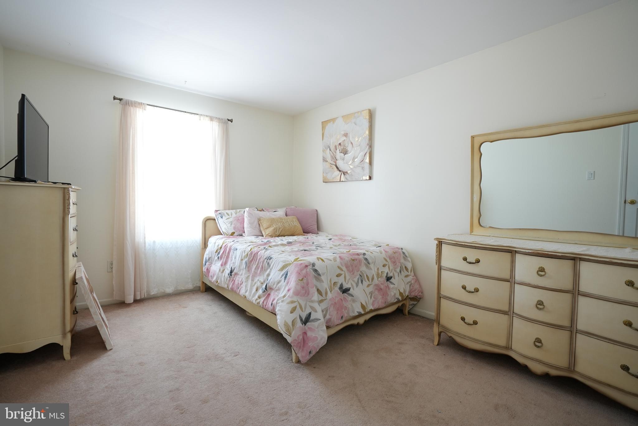 18 Cobblestone Court Sicklerville, NJ 08081 - Photo 33 of 56 a bedroom with a bed and a dresser in it