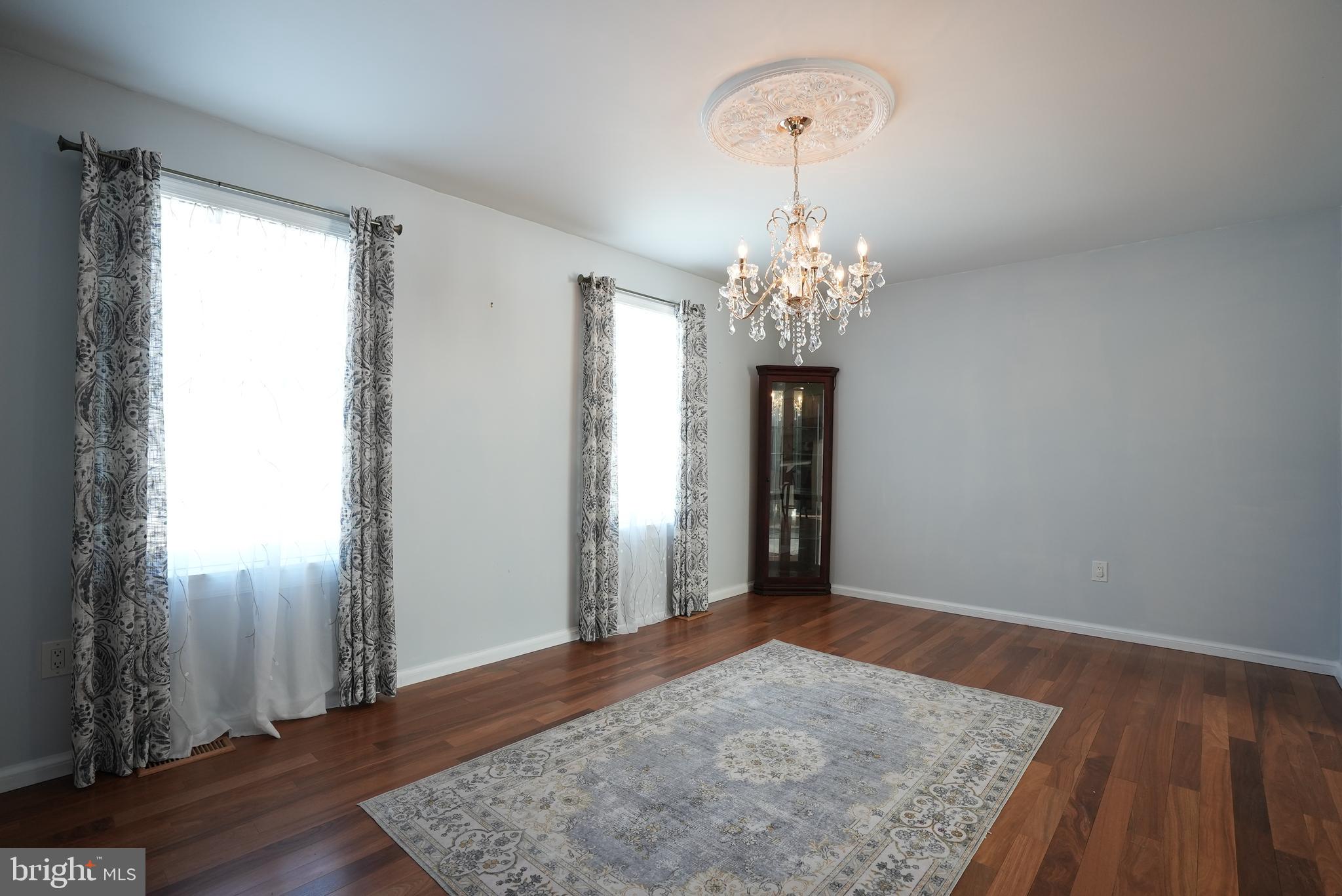 18 Cobblestone Court Sicklerville, NJ 08081 - Photo 5 of 56 a view of a hallway with wooden floor and a chandelier