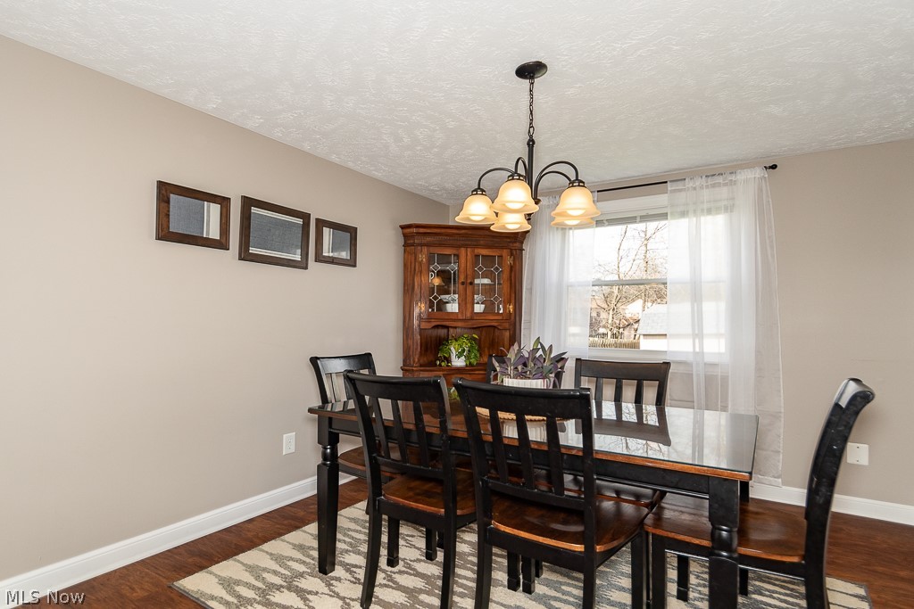 3080 Gale Road Willoughby, OH 44094 - Photo 6 of 45 Dining space featuring dark hardwood / wood-style floors, a textured ceiling, and a chandelier