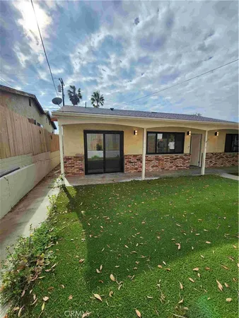 a front view of house with yard and outdoor seating