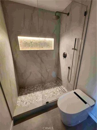 a bathroom with a toilet and a shower