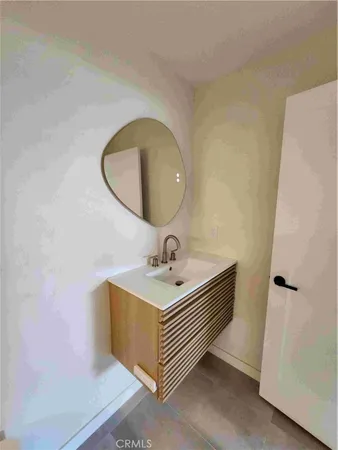 a bathroom with a sink a mirror and vanity