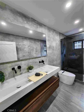 a spacious bathroom with a double vanity sink toilet and shower
