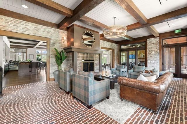a view with granite countertop a sink and cabinets