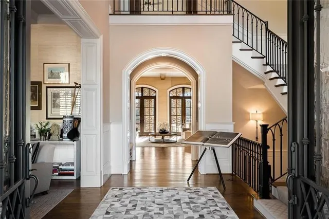 a living room with furniture and large windows