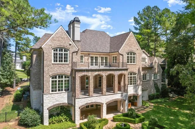 an aerial view of residential houses with outdoor space and trees all around