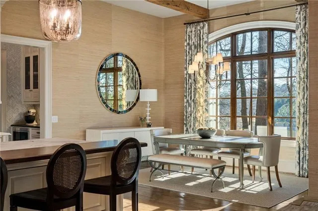 a view of a swimming pool with lawn chairs under an umbrella