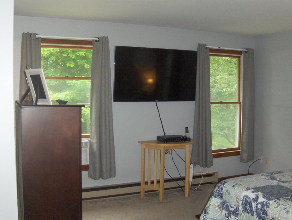 65 North Sturbridge Road Charlton, MA 01507 - Photo 16 of 30 a bedroom with a bed and a flat screen tv