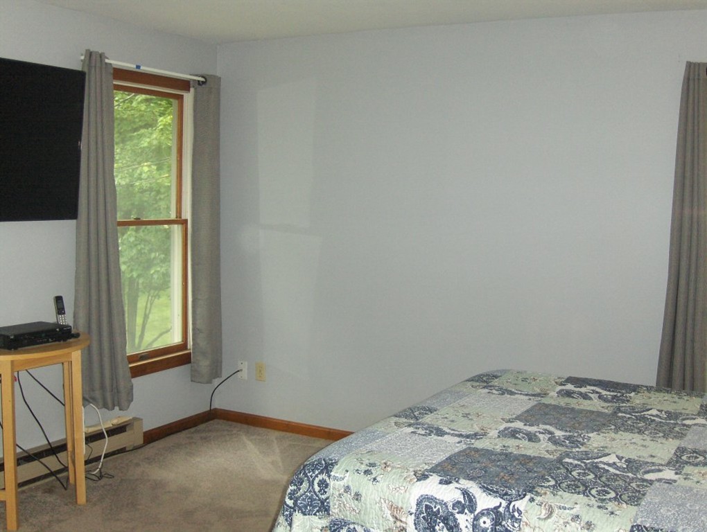 65 North Sturbridge Road Charlton, MA 01507 - Photo 17 of 30 a bedroom with a bed and a window