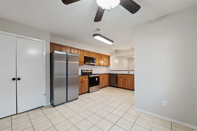 a kitchen with stainless steel appliances a refrigerator and a sink